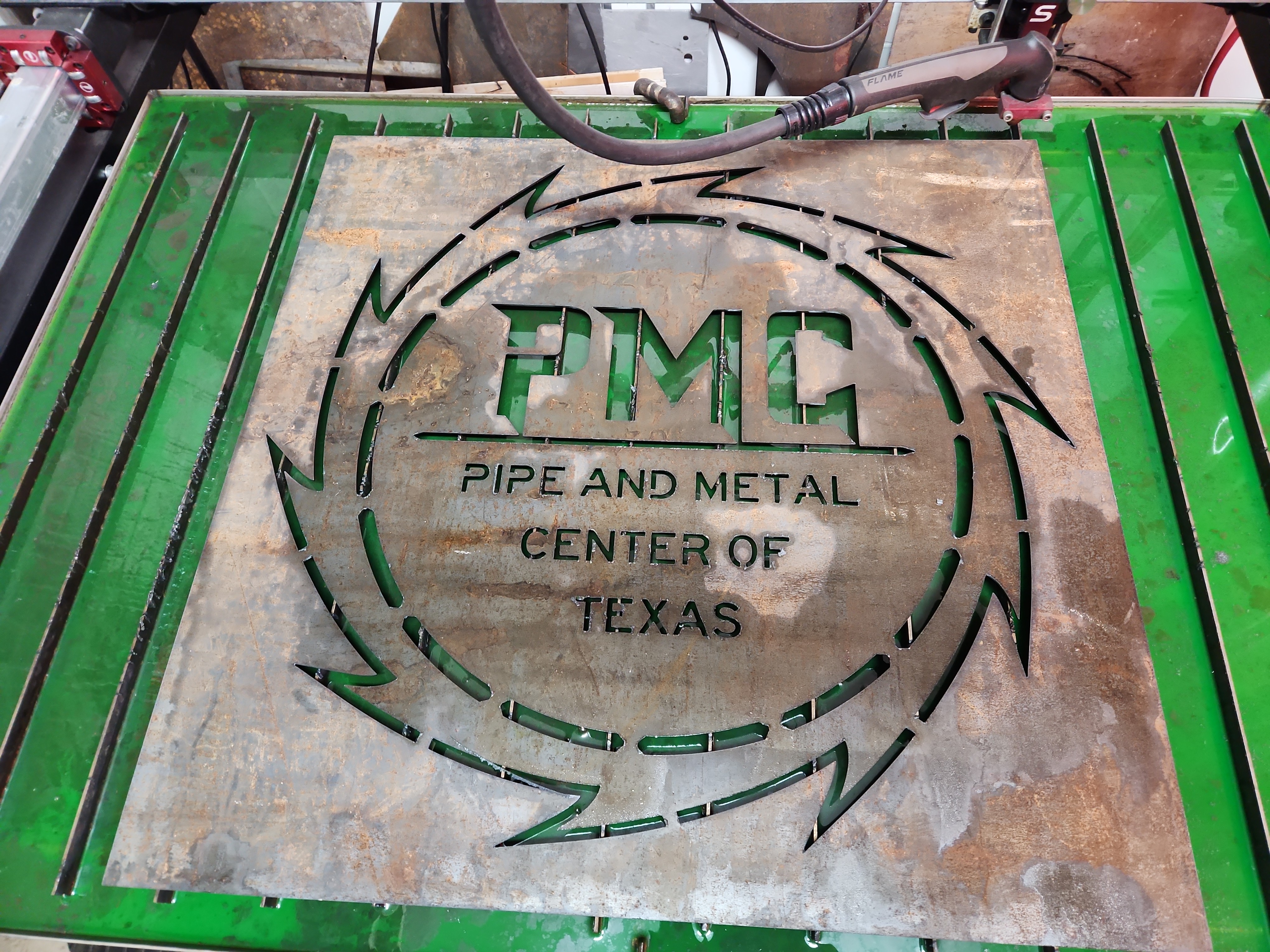 PMC Pipe and Metal Center of Texas plasma cut sign on the plasma table