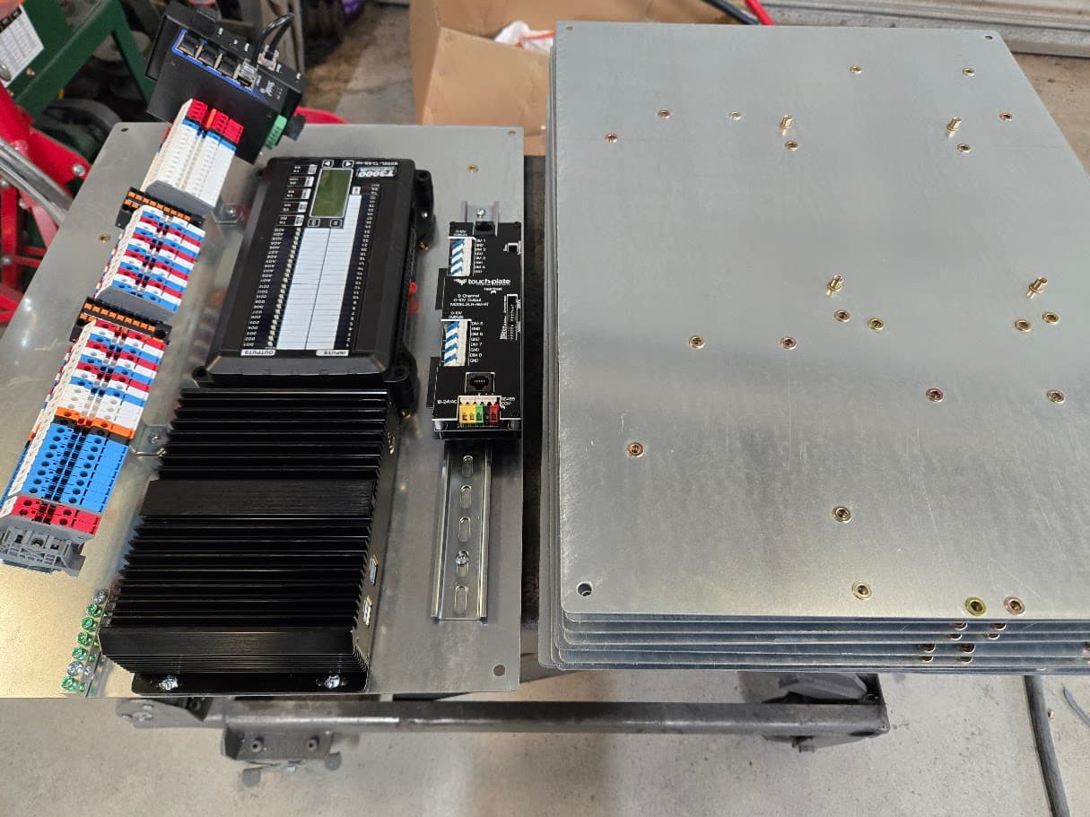 Small bracket batch 0010 plates and control hardware staged in the shop