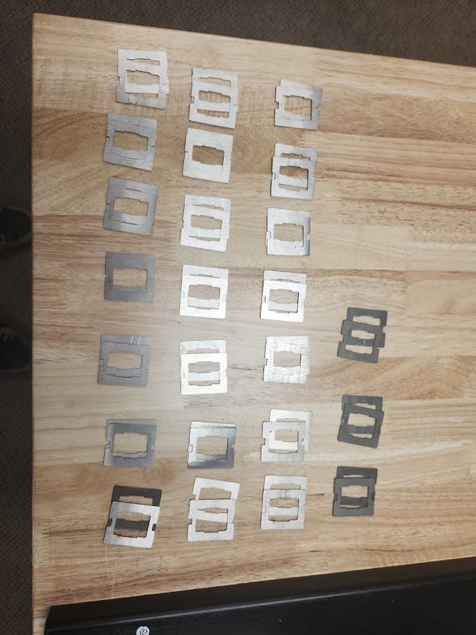 Small bracket batch 003 cut pieces arranged on a wood table