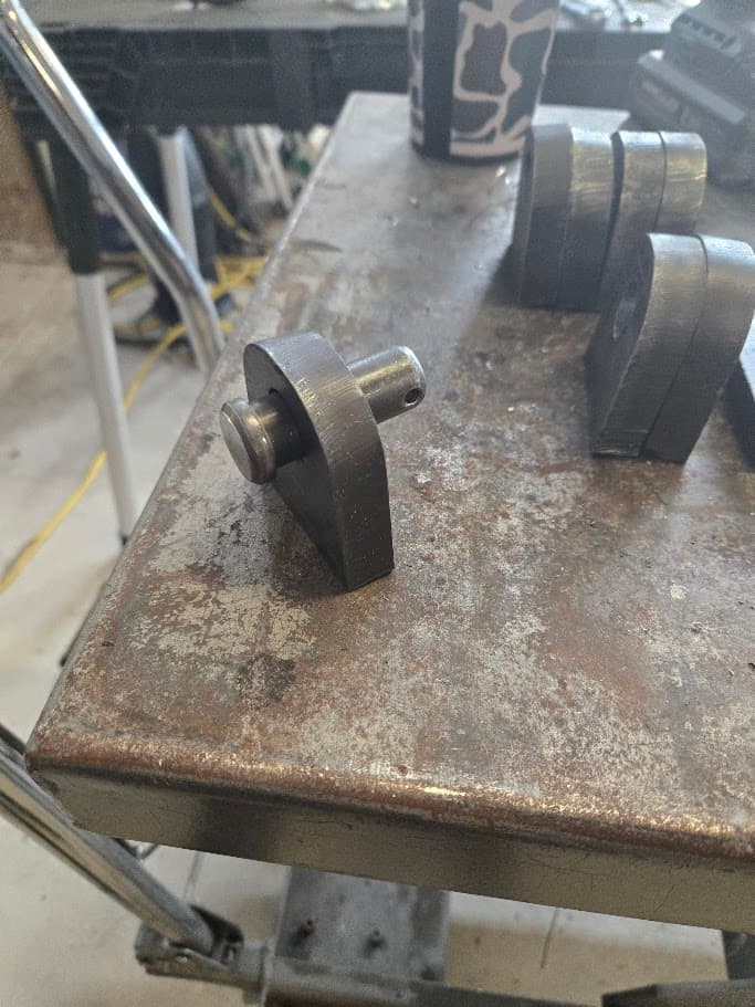 Structural steel bracket part on a shop table