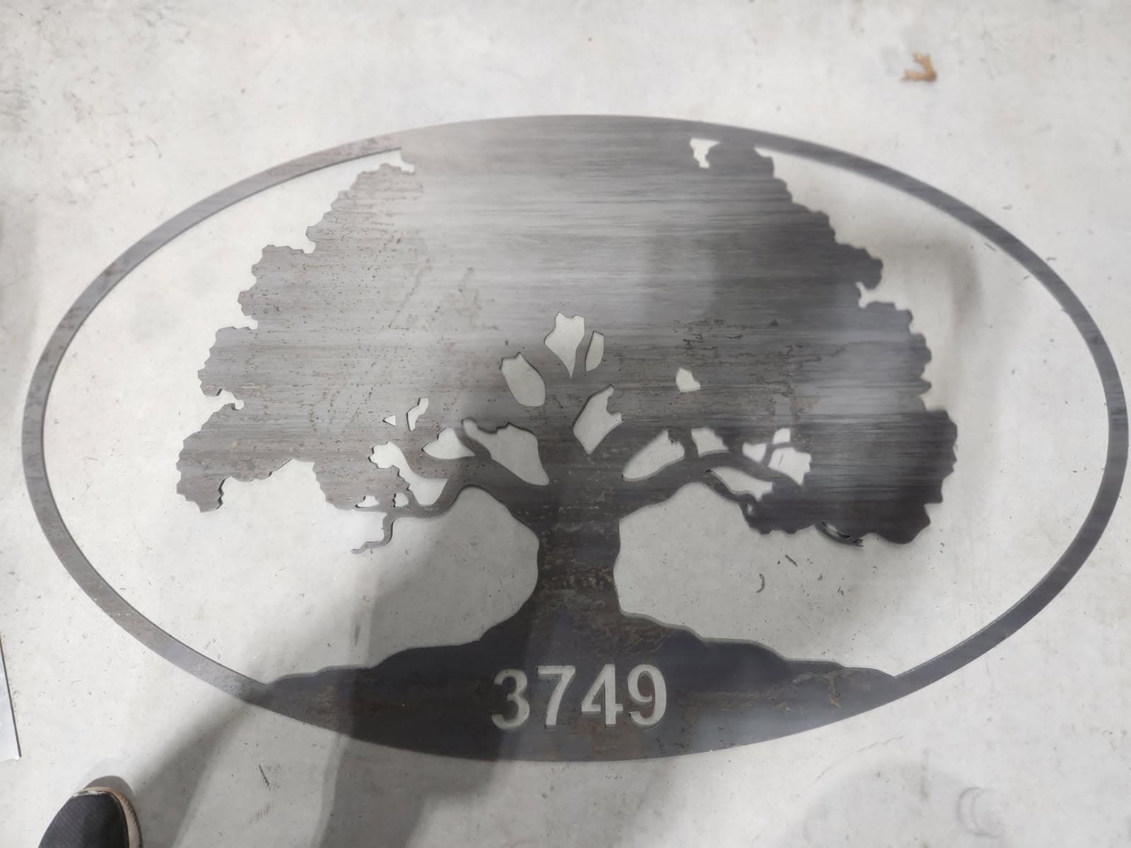 Oval tree ranch sign cut from metal with address numbers