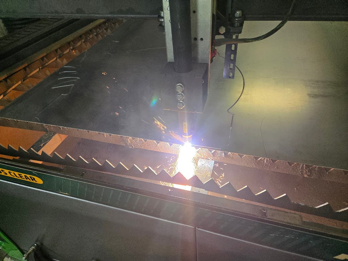CNC plasma torch cutting steel plate on the plasma table