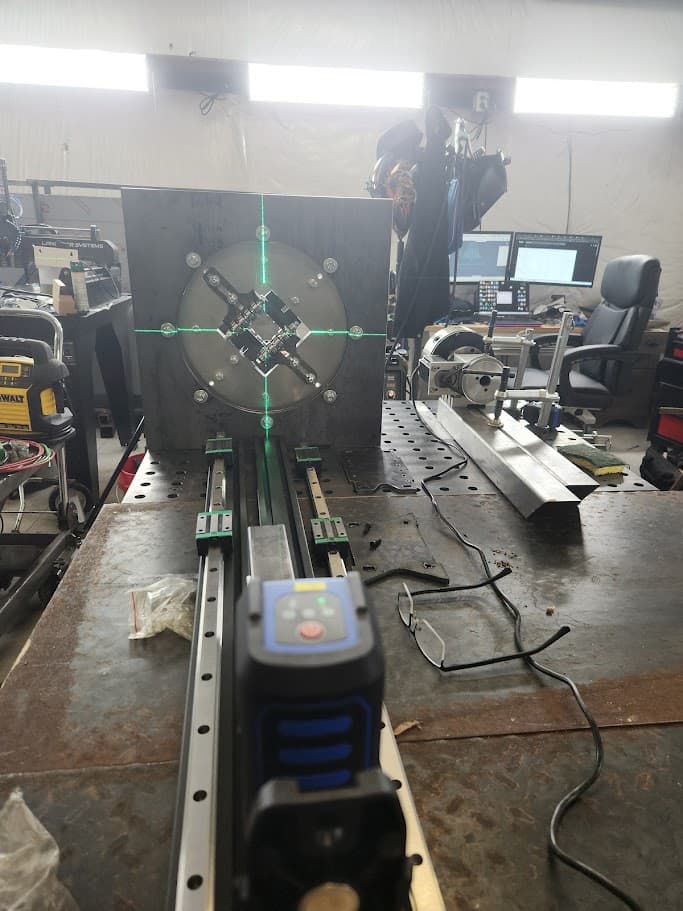 Shop fabrication table with alignment laser and metal fixture setup